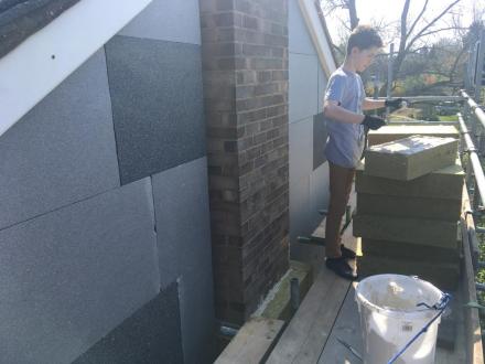 Conor preparing EWI panels on scaffolding